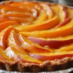 Ingredients and instructions for a classic peach cobbler recipe, including options for using peeled or unpeeled peaches.